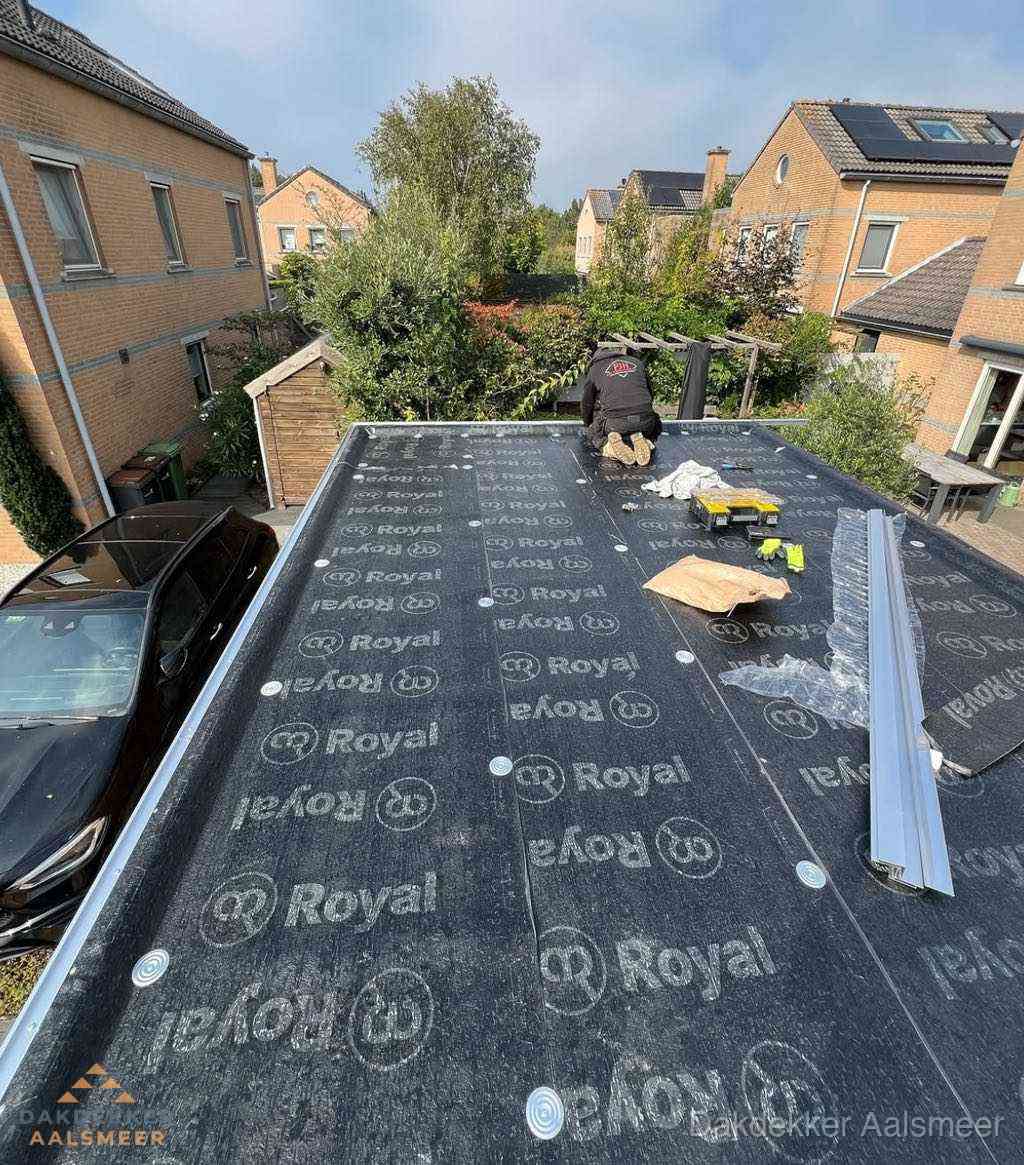Dakdekker aan het werk op plat dak renovatie in Aalsmeer