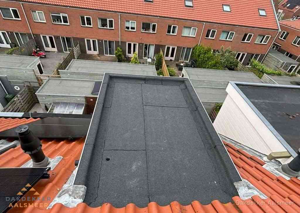 Plat dak met bitumen bedekking naast dakkapel in Aalsmeer